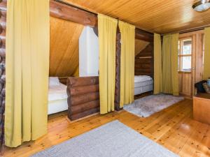 una camera con due letti in una casa di legno di Holiday Home Villa irene by Interhome a Parikka