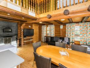 a dining room with a table and a fireplace at Holiday Home Villa irene by Interhome in Parikka