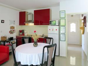 a kitchen and dining room with a table and a refrigerator at Apartment Stella - CKV300 by Interhome in Bribir