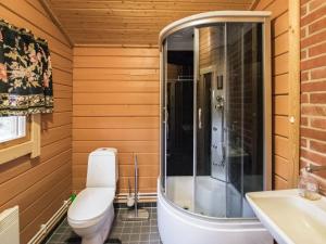 a bathroom with a toilet and a shower and a sink at Holiday Home Mäntymäki by Interhome in Kelkala