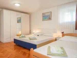 a bedroom with two beds and a cabinet at Holiday Home Stanka - SNJ218 by Interhome in Sveti Juraj