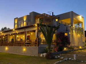 a large building with lights in front of it at Houmas Apartments in Palaiochora