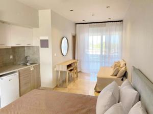 a kitchen and a living room with a bed and a table at Houmas Apartments in Palaiochora