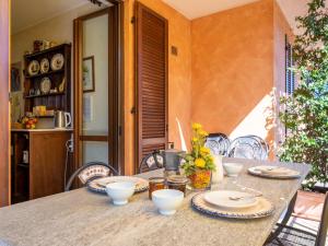 a table with plates and bowls on top of it at Holiday Home I Briganti by Interhome in Narzole