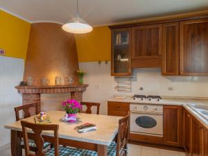 a kitchen with a table and a stove top oven at Holiday Home Ludovica by Interhome in Soldano
