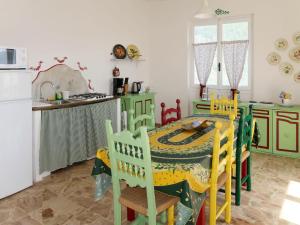 a kitchen with a table and chairs and a refrigerator at Holiday Home Casa Barba by Interhome in Caravonica