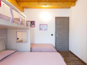 A bed or beds in a room at Holiday Home Gelsomini - CCO522 by Interhome