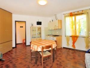 una cucina con tavolo e sedie in una stanza di Apartment Villaggio Tivoli-1 by Interhome a Bibione