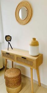 a wooden table with a mirror and a stool at LE "PETIT GERVAIS" pour un instant parfait ! in Saint-Gervais-les-Bains