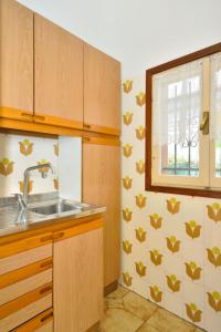 una cucina con un lavandino e una finestra di Holiday Home Cassiopea-1 by Interhome a Bibione