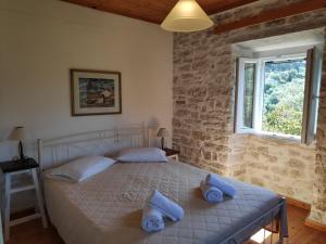 a bedroom with a bed with blue towels on it at Villa Christina in Lákka