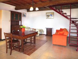 a living room with a dining room table and a staircase at Holiday Home Ginestre 4 by Interhome in Santo