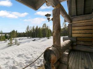 a porch of a log cabin with a snow covered field at Holiday Home Peikkola by Interhome in Ruka