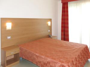 a hotel room with a bed and a window at Apartment Casa del Mar-2 by Interhome in Roseto degli Abruzzi +13 photos