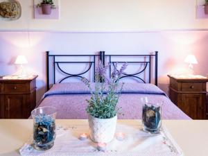 a bedroom with a bed with a vase of flowers on a table at Apartment Monolocale - Ranch Hotel by Interhome in Scarlino