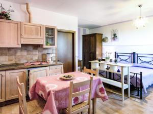 a kitchen and dining room with a table and a bed at Apartment Monolocale - Ranch Hotel by Interhome in Scarlino