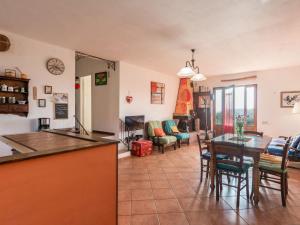 a kitchen and living room with a table and chairs at Holiday Home Valmarinella by Interhome in Ravi +21 photos