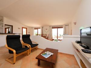 a living room with two chairs and a coffee table at Holiday Home Alba by Interhome in Greuli  +25 photos