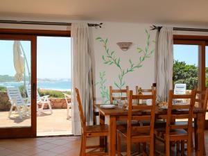 a dining room with a table and a view of the ocean at Holiday Home Alba by Interhome in Greuli 