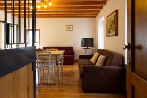 a living room with a couch and a table at Albergo Diffuso Polcenigo P.Lacchin in Polcenigo
