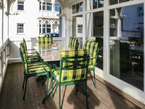 a dining room table and chairs on a porch at Apartment Juliusruh-5 by Interhome in Juliusruh