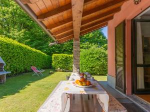 a table with a bowl of fruit on a patio at Holiday Home Oasi & Relax by Interhome in Colico
