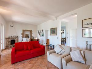 a living room with a red couch and two couches at Holiday Home Casa Judith by Interhome in Podere Cernaia