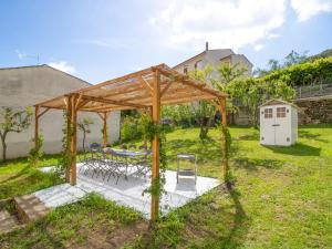 a wooden pavilion with a table and chairs in a yard at Holiday Home Mimmina by Interhome in Capodimonte