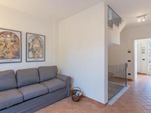 a living room with a couch and a staircase at Apartment Michelangelo II by Interhome in Marina di Pietrasanta