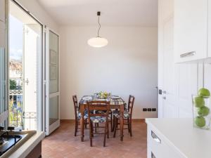 a dining room with a table and chairs in a kitchen at Apartment Michelangelo II by Interhome in Marina di Pietrasanta