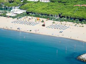 an aerial view of a beach with people and umbrellas at Holiday Home Residence Village-1 by Interhome in Cavallino-Treporti