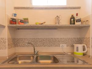 a kitchen with a sink and a counter top at Apartment Glicine by Interhome in Perledo +30 photos