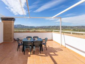 a patio with a table and chairs on a balcony at Apartment Frontal Montañas by Interhome in Oropesa del Mar
