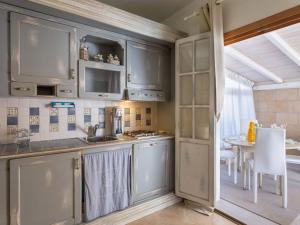 a kitchen with stainless steel cabinets and a table at Holiday Home Stella Marina by Interhome in Marina di Pietrasanta