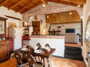 a kitchen with a wooden table with chairs and a counter at Holiday Home Carametto by Interhome in Andagna