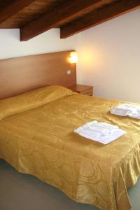 a bed with two white towels on top of it at Apartment Casa del Mar-1 by Interhome in Roseto degli Abruzzi +13 photos