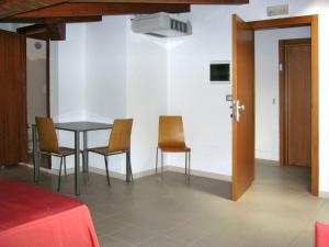 a table and chairs in a room with a door at Apartment Casa del Mar-1 by Interhome in Roseto degli Abruzzi