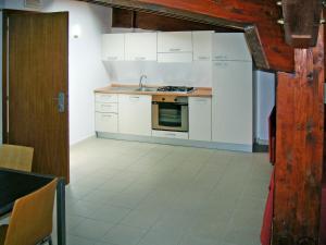 a kitchen with white cabinets and a stove top oven at Apartment Casa del Mar-1 by Interhome in Roseto degli Abruzzi