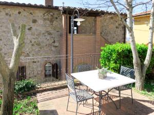 a white table and chairs on a patio at Apartment Giada by Interhome in Santa Luce