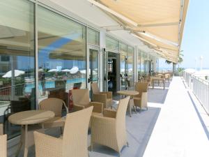 a row of tables and chairs on a balcony at Apartment Casa del Mar-1 by Interhome in Roseto degli Abruzzi
