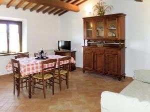 a living room with a table with chairs and a tv at Apartment Giada by Interhome in Santa Luce