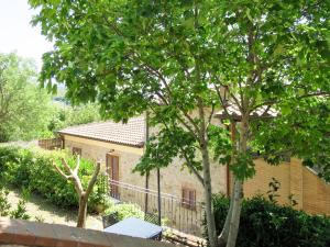 a brick house with a tree in front of it at Apartment Giada by Interhome in Santa Luce
