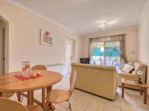 a living room with a table and a couch at Apartment Alqueria Sol by Interhome in Denia