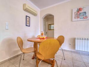 a dining room with a wooden table and chairs at Apartment Alqueria Sol by Interhome in Denia