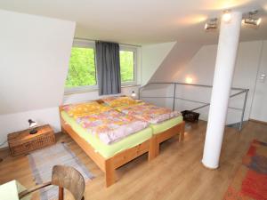 a bedroom with a bed and a large window at Holiday Home Neznašov by Interhome in Neznašov