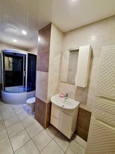 a bathroom with a sink and a toilet at Мини-отель in Kropyvnytskyi +56 photos