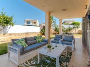 a patio with a couch and two chairs and a table at Villa Son Jil by Interhome in Alcudia