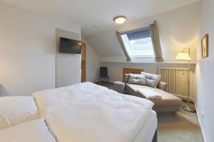 a bedroom with a large bed and a couch at Ruhwarder Mühle in Ruhwarden