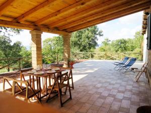 a patio with a table and chairs on a roof at Apartment L'Essiccatoio-2 by Interhome in Bolsena