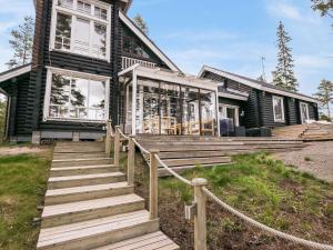 a house with wooden stairs leading up to it at Holiday Home Le club 44 by Interhome in Kausala